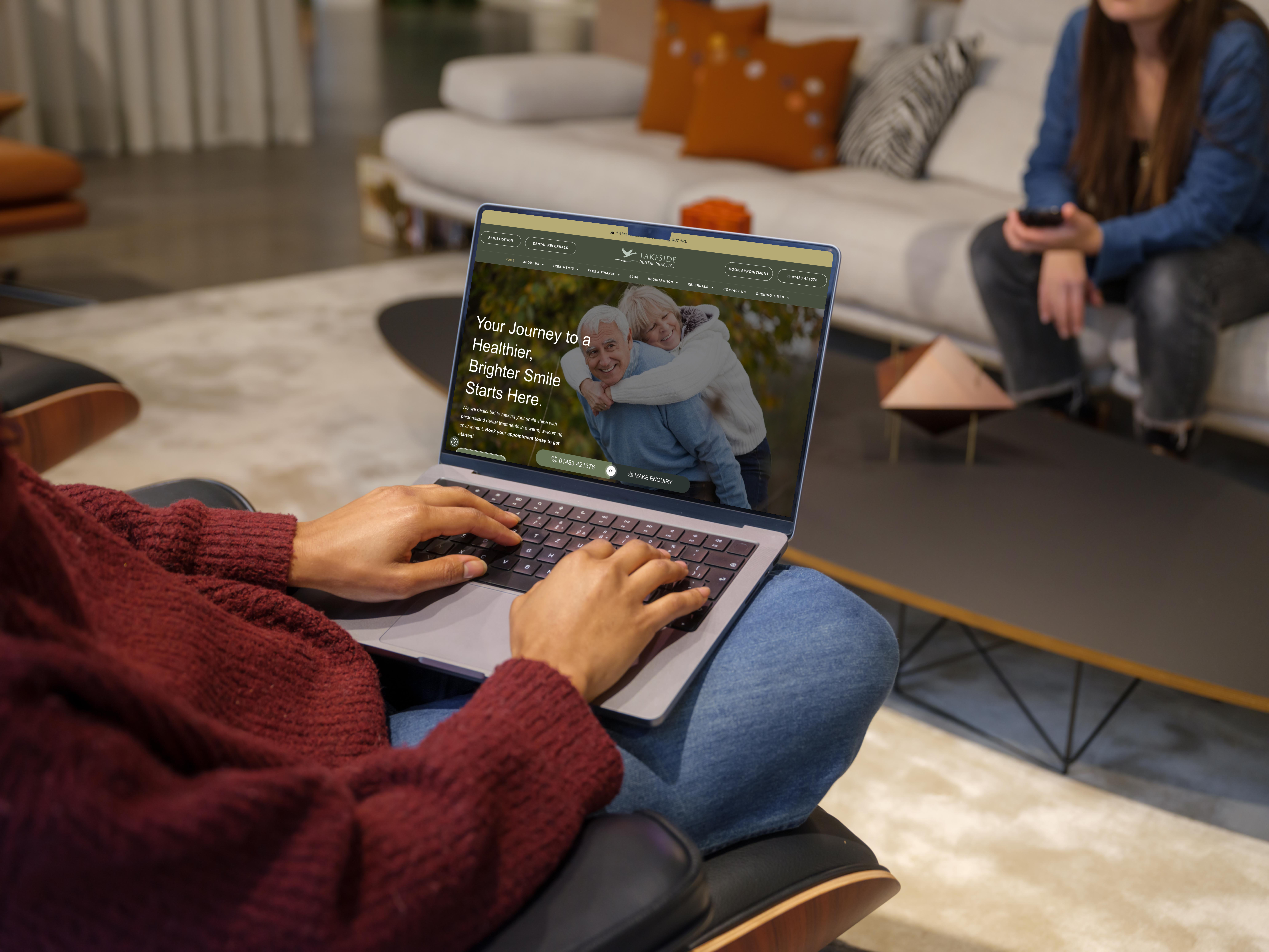Mockuuups woman in red sweater typing on a mac book pro 14 mockup